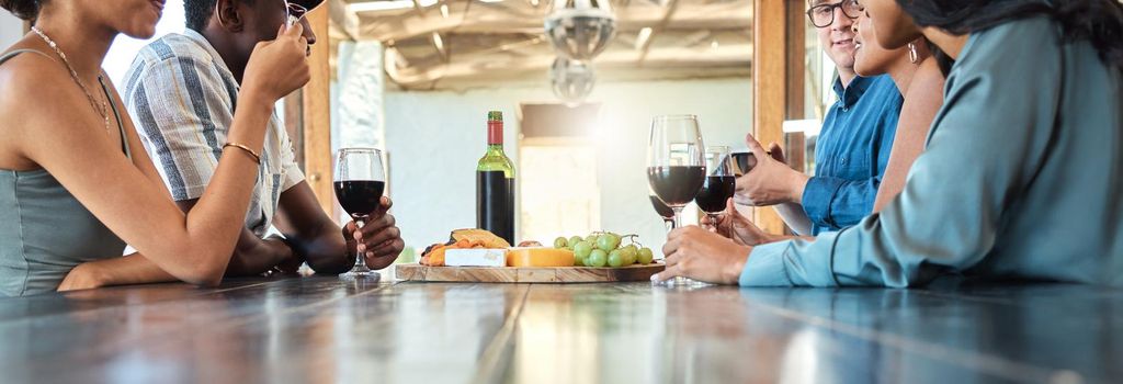 Wine tasting and cheese platter with friends at a restaurant or estate in the winery in the agriculture or sustainability industry. Drinking alcohol with a group on a farm to drink or taste.