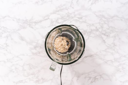 Flat lay. Blending ingredients for healthy breakfast strawberry banana smoothie in a kitchen blender.