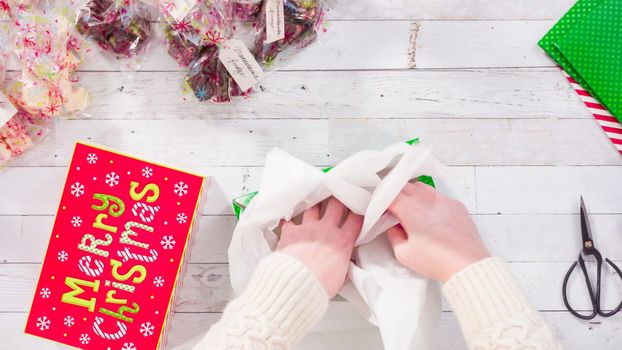 Flat lay. Step by step. Packaging homemade fudge and cookies into a Christmas gift box.