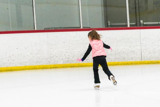 Little skater practicing her elements at the morning figure skating practice.