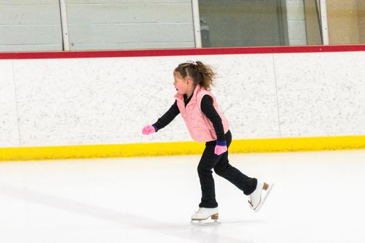 Little skater practicing her elements at the morning figure skating practice.