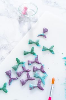 Homemade chocolate mermaid tails covered with glitter dust.