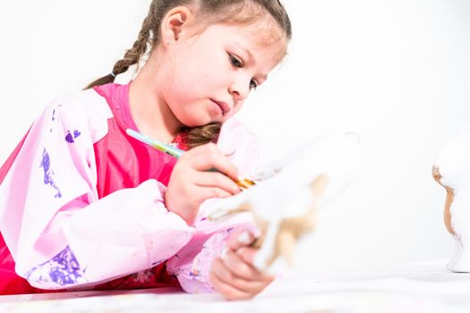 Little girl working on her art project for distance learning at home during COVID-19 pendemic.