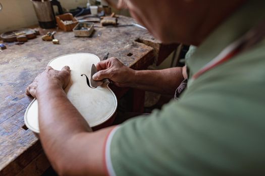 violinmaker at work in his italian workshop