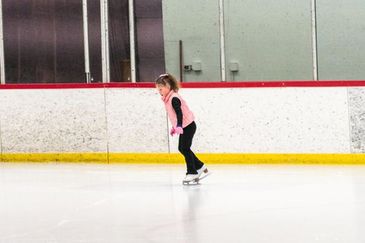 Little skater practicing her elements at the morning figure skating practice.