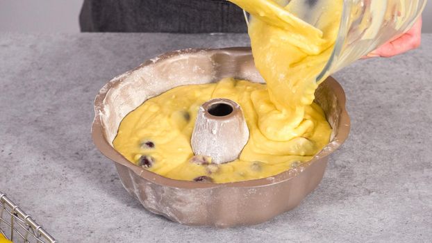 Step by step. Pouring cake batter into the bundt cake pan.