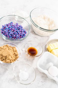 Ingredients in glass mixing bowls to bake unicorn chocolate chip cookies.