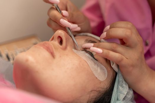 Eyelash extension procedure. Woman eye with long eyelashes. lashes, close up, macro, selective focus