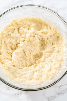 Mashed potatoes. Mashing cooked potatoes in a glass mixing bowl with a hand mixer made creamy mashed potatoes.