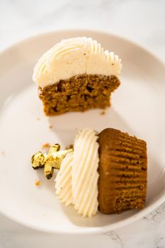 Eating freshly baked gingerbread cupcakes with eggnog buttercream frosting and topped with a gingerbread man.