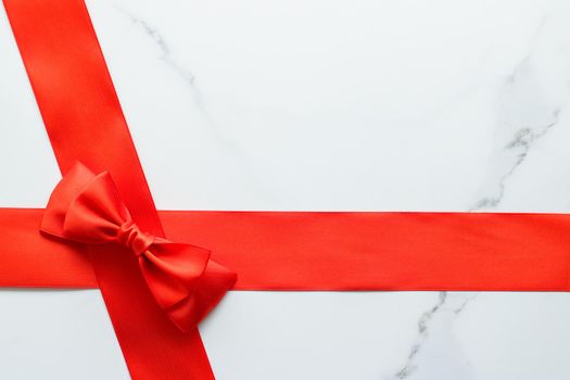 Holiday decor, feminine design and flatlay concept - Red silk ribbon on marble, top view