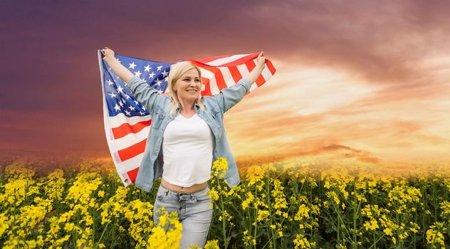 Young cute woman holding an united states flag.