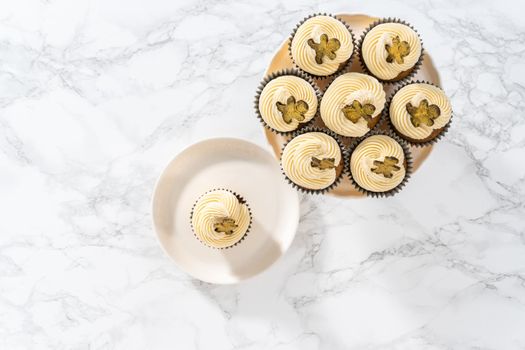 Eating freshly baked gingerbread cupcakes with eggnog buttercream frosting and topped with a gingerbread man.