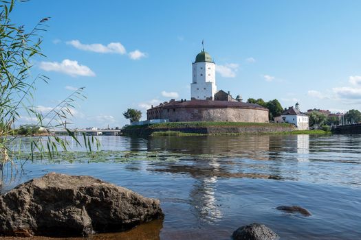 Vyborg, Leningrad region, Russia. - August 27, 2022. View of the medieval knight's castle from the city embankment. Selective focus.