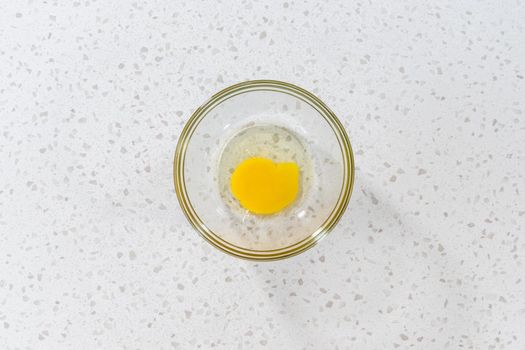 Flat lay. Whisking an egg to make an egg wash for turkey empanadas.