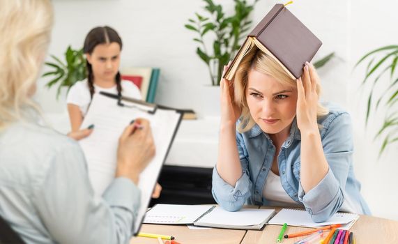 Talking is key to understanding. Parent and child seeing psychologist together. Counseling therapist and mother listening to preteen daughter sharing school news, telling story and answering questions