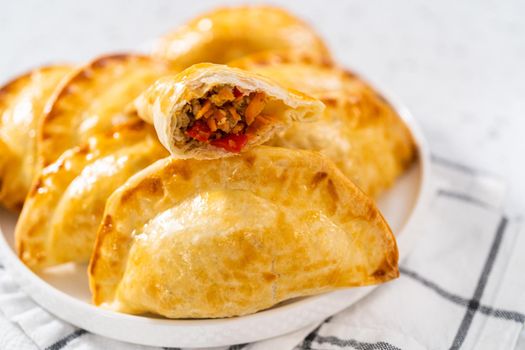 Freshly baked turkey empanadas on the kitchen counter.