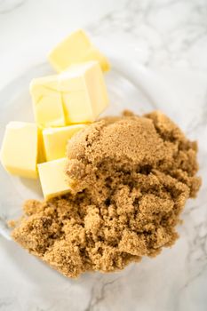 Mixing ingredients in a large glass mixing bowl to bake gingerbread cupcakes.