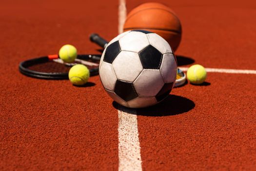 Sport games equipment - balls, rackets - on court