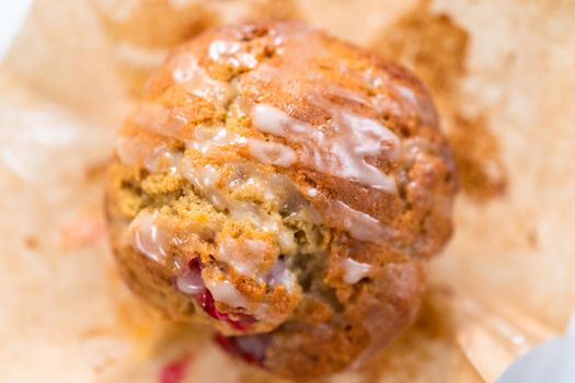 Freshly baked cranberry muffins in brown paper muffin cups.