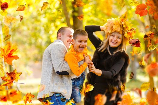 Family playing in autumn park having fun. High quality photo