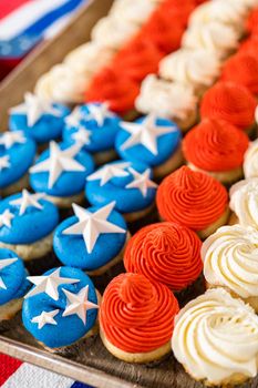 Arranging mini vanilla cupcakes in the shape of the American flag.