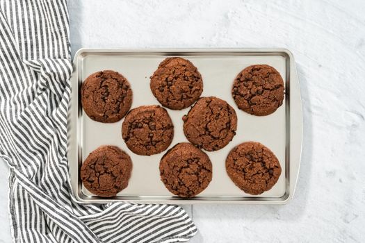 Flat lay. Freshly baked double chocolate chip cookies on a baking sheet.