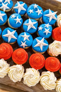 Arranging mini vanilla cupcakes in the shape of the American flag.