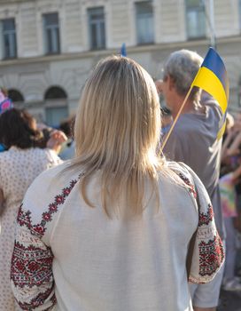 Lady in traditional national clothes with Ukrainian flag. High quality photo
