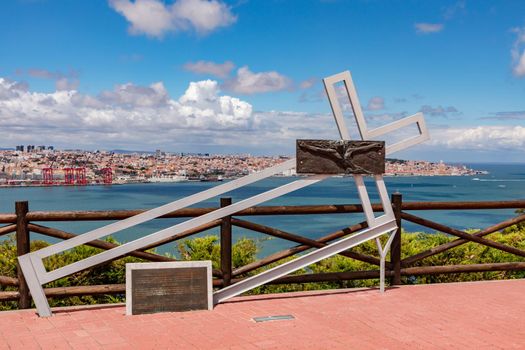 Modern cross on the railing of the viewpoint at Cristo Rei in Almada near Lisbon, Portugal