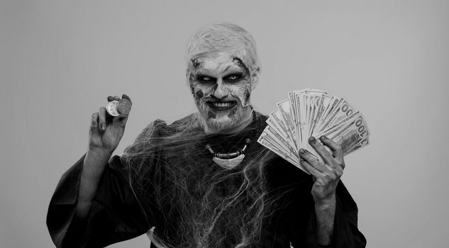 Creepy smiling man with bloody scars face, Halloween zombie showing golden bitcoins with money dollar cash banknotes. Achievement career wealth, cryptocurrency investment, mining, future technology