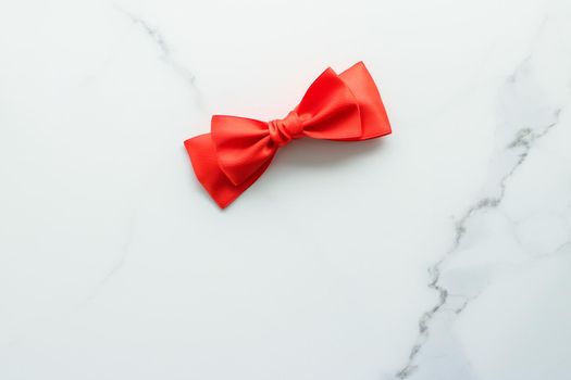 Holiday decor, feminine design and flatlay concept - Red silk ribbon on marble, top view