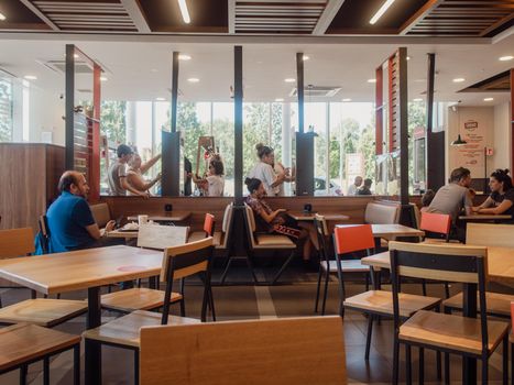 woman orders meal in the electronic touch screen terminal menu in the fastfood restaurant Burger King