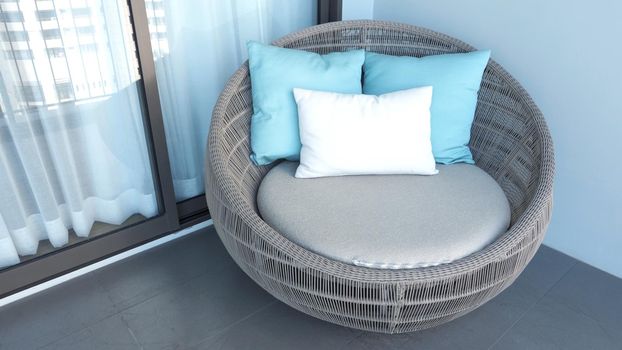 Outdoor beach chair on the hotel room balcony or terrace which made from natural wood called rattan and brown color round shape and look luxury for relaxing or sleeping or for party.