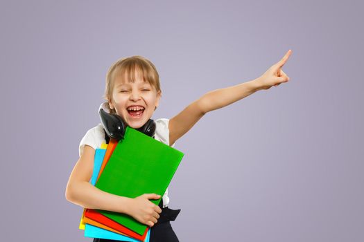 Smiling active excellent best student schoolgirl holding books and going to school wearing bag.