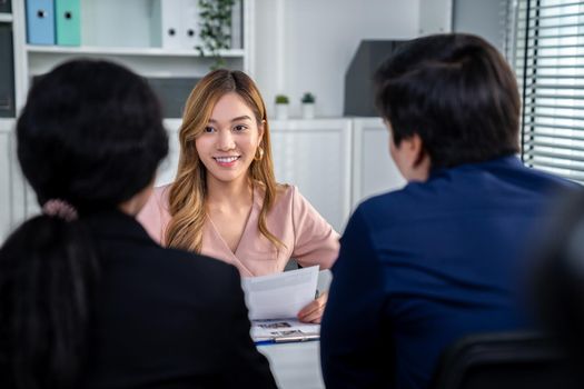 A young female asian candidate tries to impress her interviewer by being competent. International company, multicultural environment in workplace.