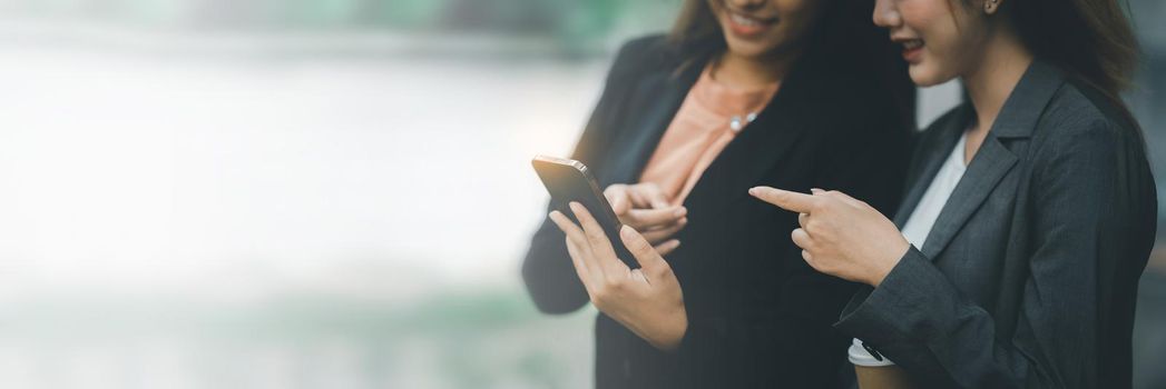 Two Asian businesswoman have video call meeting with partner by Mobile phone.