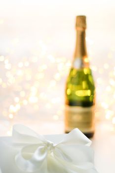 Romantic celebration, lifestyle and luxury present concept - The bottle of champagne and holiday gift box