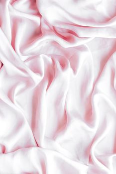 Elegant fabric texture, abstract backdrop and modern pastel colours concept - Pink soft silk waves, flatlay background