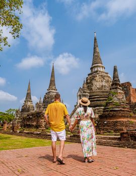 Ayutthaya, Thailand at Wat Phra Si Sanphet, a couple of men and women with a hat visiting Ayyuthaya Thailand. Tourist with map in Thailand