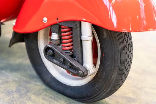 vintage scooter. Front fender, lever suspension and a wheel with a red tire for a retro scooter.