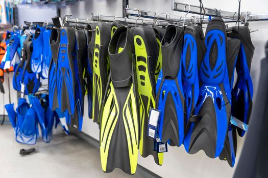 new fins for swimming on sale in a sports store. Active recreation, sports, leisure, physical activity and diving