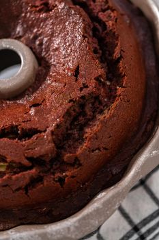 Cooling freshly baked red velvet bundt cake on a kitchen counter.