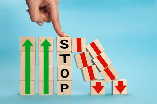 Stop wording print on wooden block cube protect wooden falling domino for risk management concept