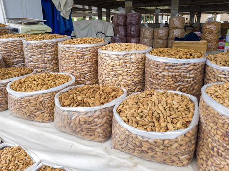 Oriental Bazaar. Almond peeled and unpeeled, nuts sales in market. Dry food, variety almonds in store. Concept of healthy eating, raw product, bazaar, diet, almond theme.