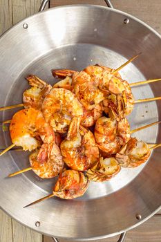 Grilled prawns on wooden skewers, shrimp kebab.