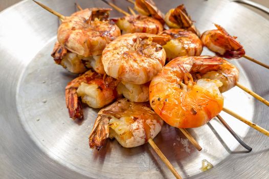 Grilled prawns on wooden skewers, shrimp kebab.