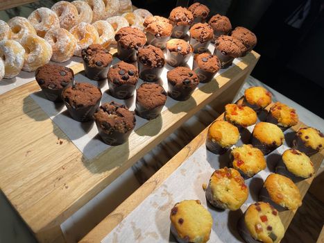 Lines of delicious chocolate and vanilla muffins Freshly baked homemade chocolate chip muffins Out of the oven muffins in muffin cups