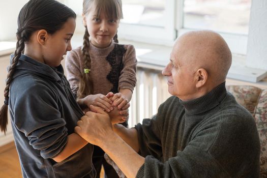 Family bonding. grandfather and child holding hands together, closeup view. Panorama.