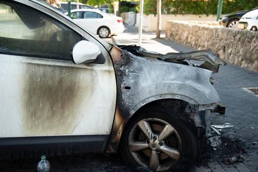ISRAEL, Tel Aviv - 15 May 2021: Vandalism or revenge, burnt car. The consequences of popular protest, burnt car, a crime. Car after fire. Auto trash. High quality photo